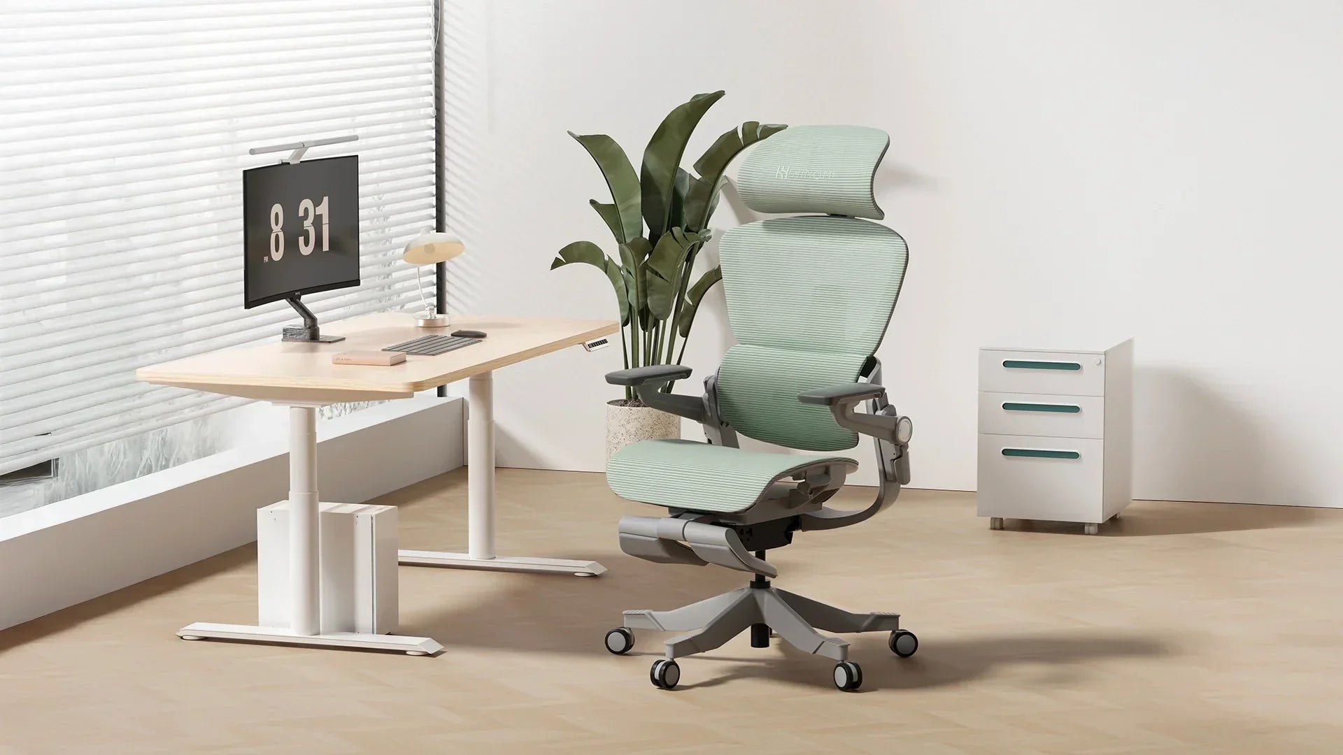 Minimalist home office featuring a green H1 Pro ergonomic chair, S1 standing desk, and greenery accents.